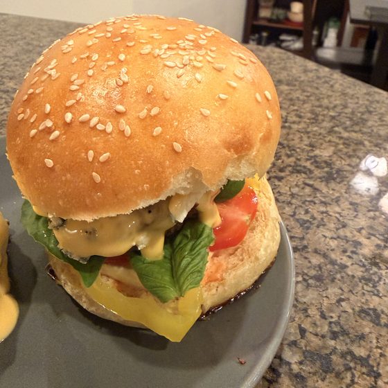 A burger built on a golden sesame-topped bun.